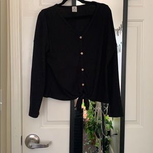 Black sweater with buttons and a tie